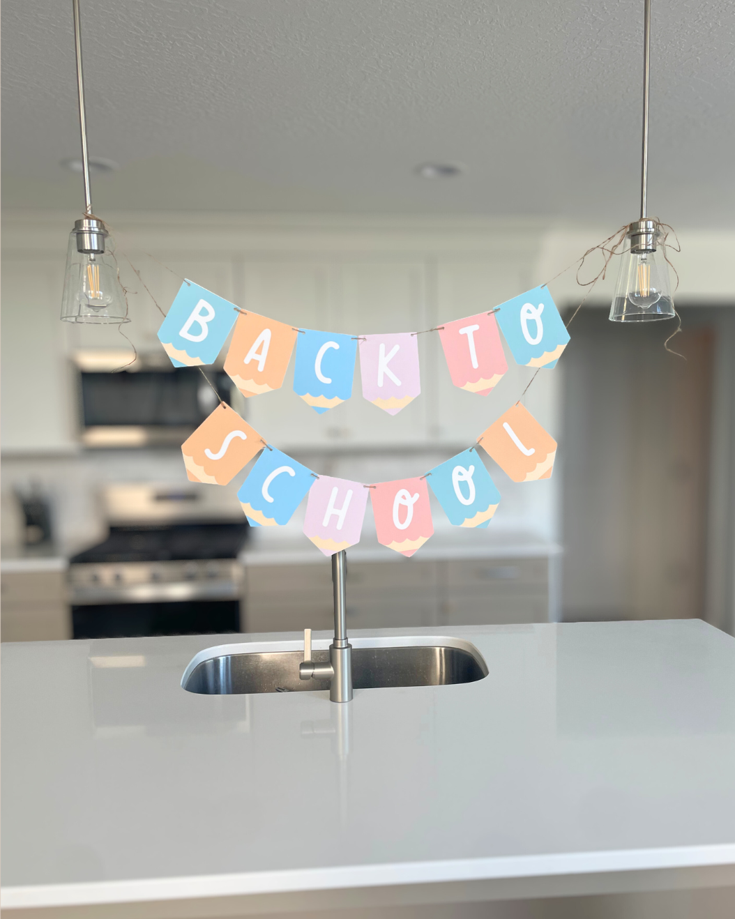 Colorful 'Back to School' banner hanging above a kitchen sink.